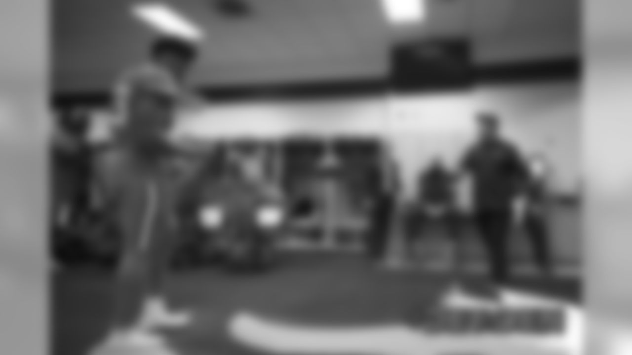 Head Coach Vic Fangio tosses a game ball to Dre'Mont Jones inside a jubilant locker room the Broncos' game against the Detroit Lions at Empower Field at Mile High on December 22, 2019. (Photo by Gabriel Christus)