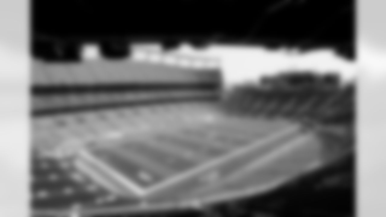 Members of the stadium's turf crew paint the field at Empower Field at Mile High on September 23, 2021 ahead of the team's Week 3 home opener. (Photo by Ben Swanson)