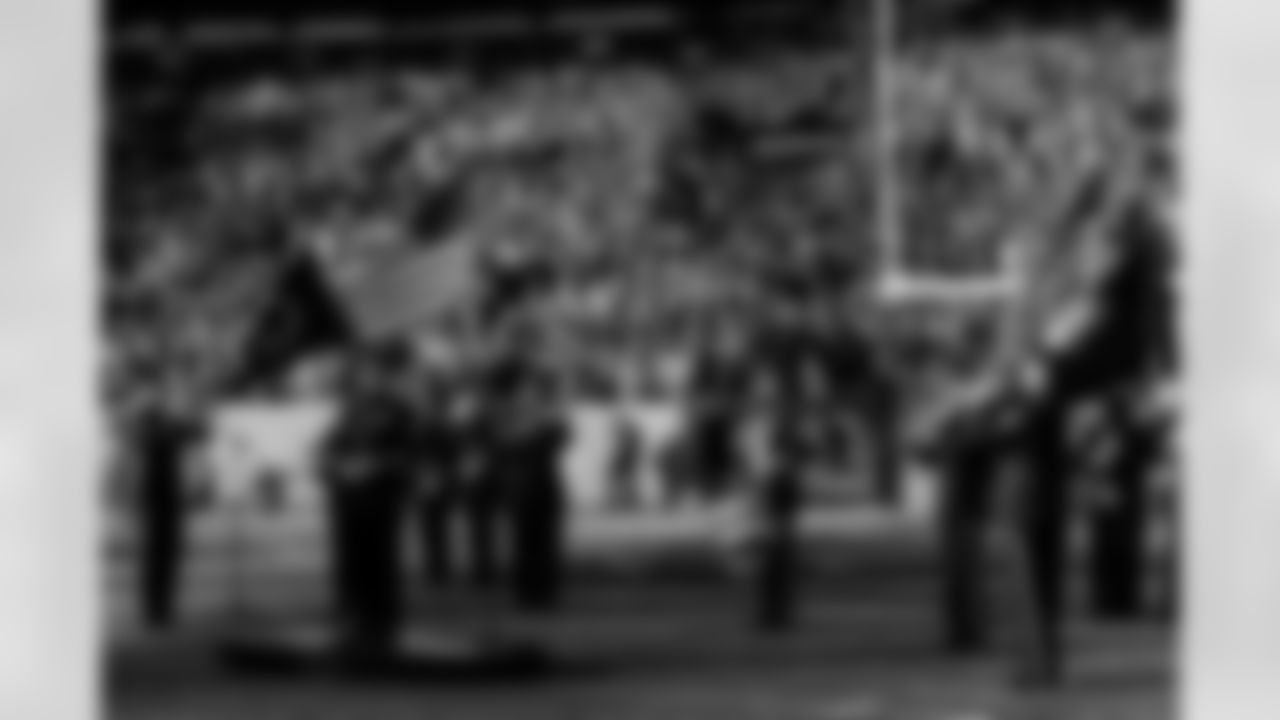 Military service members perform the national anthem during the Broncos' Week 10 game against the Philadelphia Eagles at Empower Field at Mile High in Denver, Colorado on November 14, 2021. (Photo by Eric Lars Bakke)