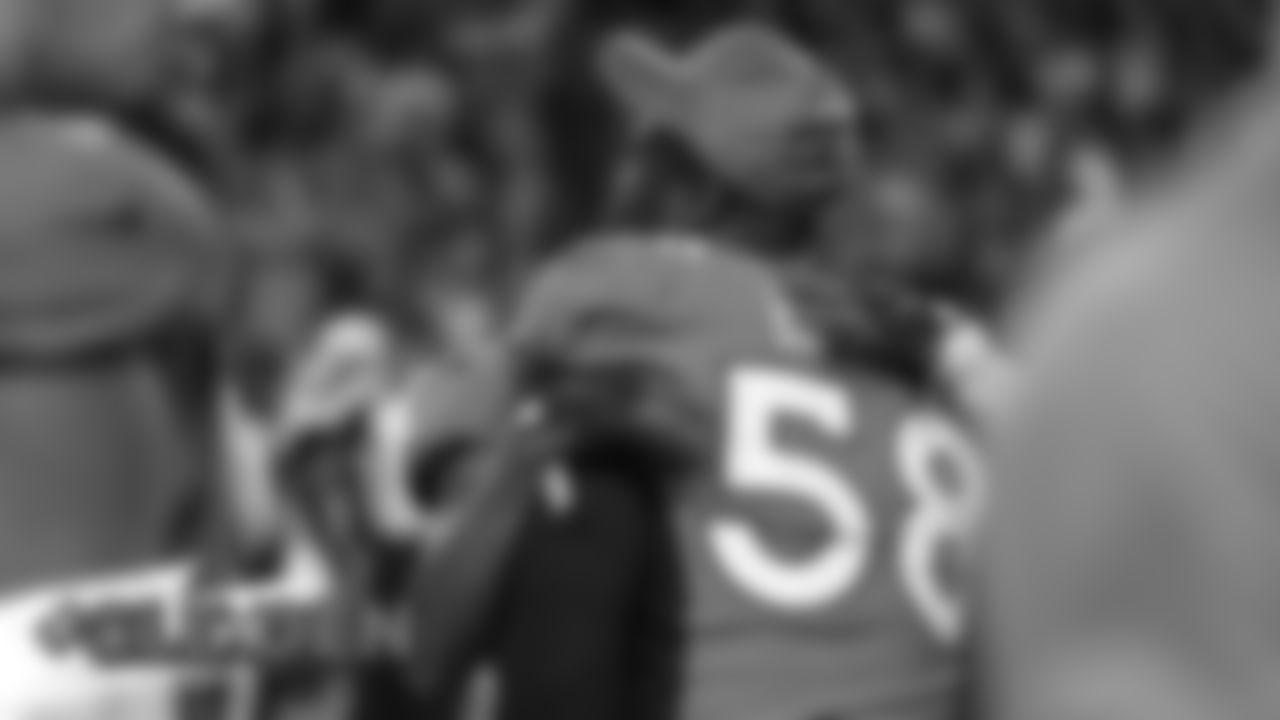 Chris Harris Jr. hugs Von Miller after the Broncos' game against the Cleveland Browns at Empower Field at Mile High on November 3, 2019. (Photo by Ben Swanson)