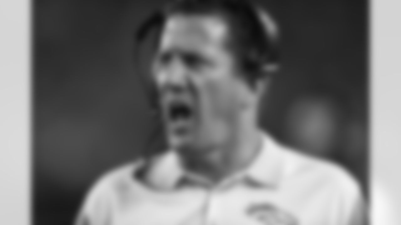 Denver Broncos quarterback coach Greg Knapp calls out to players during third quarter action against the Arizona Cardinals in the NFL game at Sports Authority Field in Denver, CO September 3, 2015.