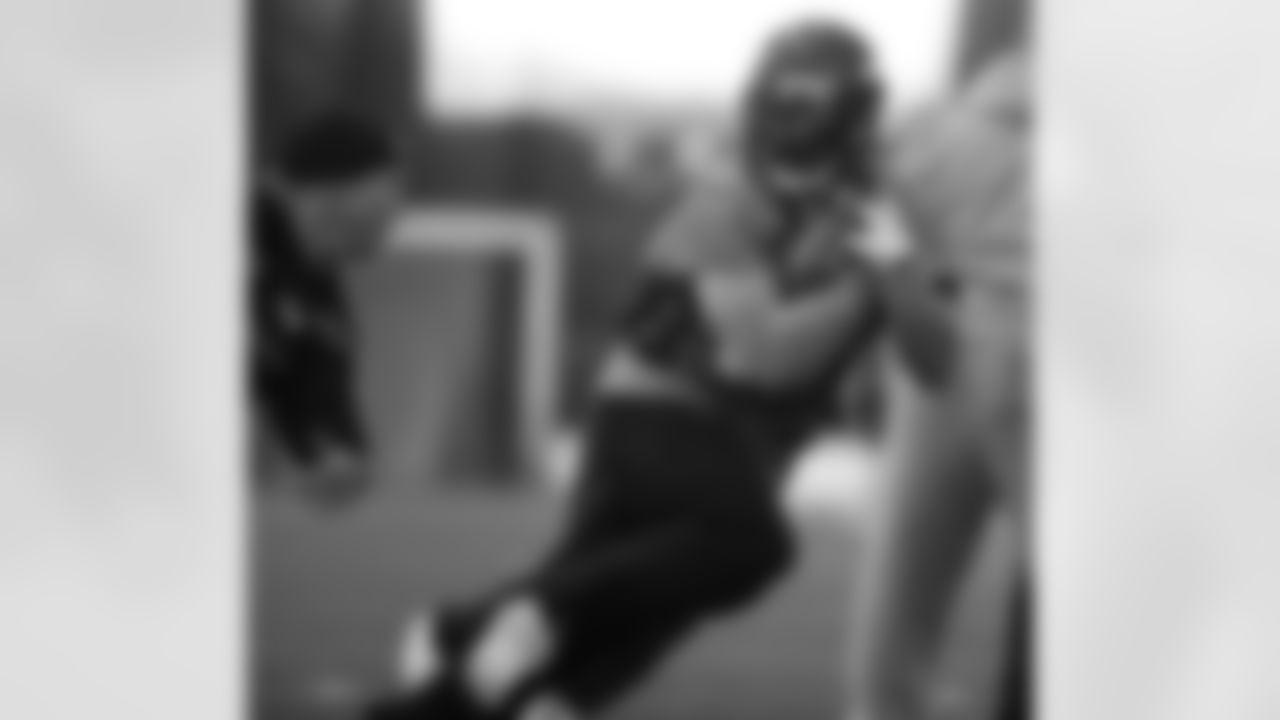 The Broncos running backs work through a drill.