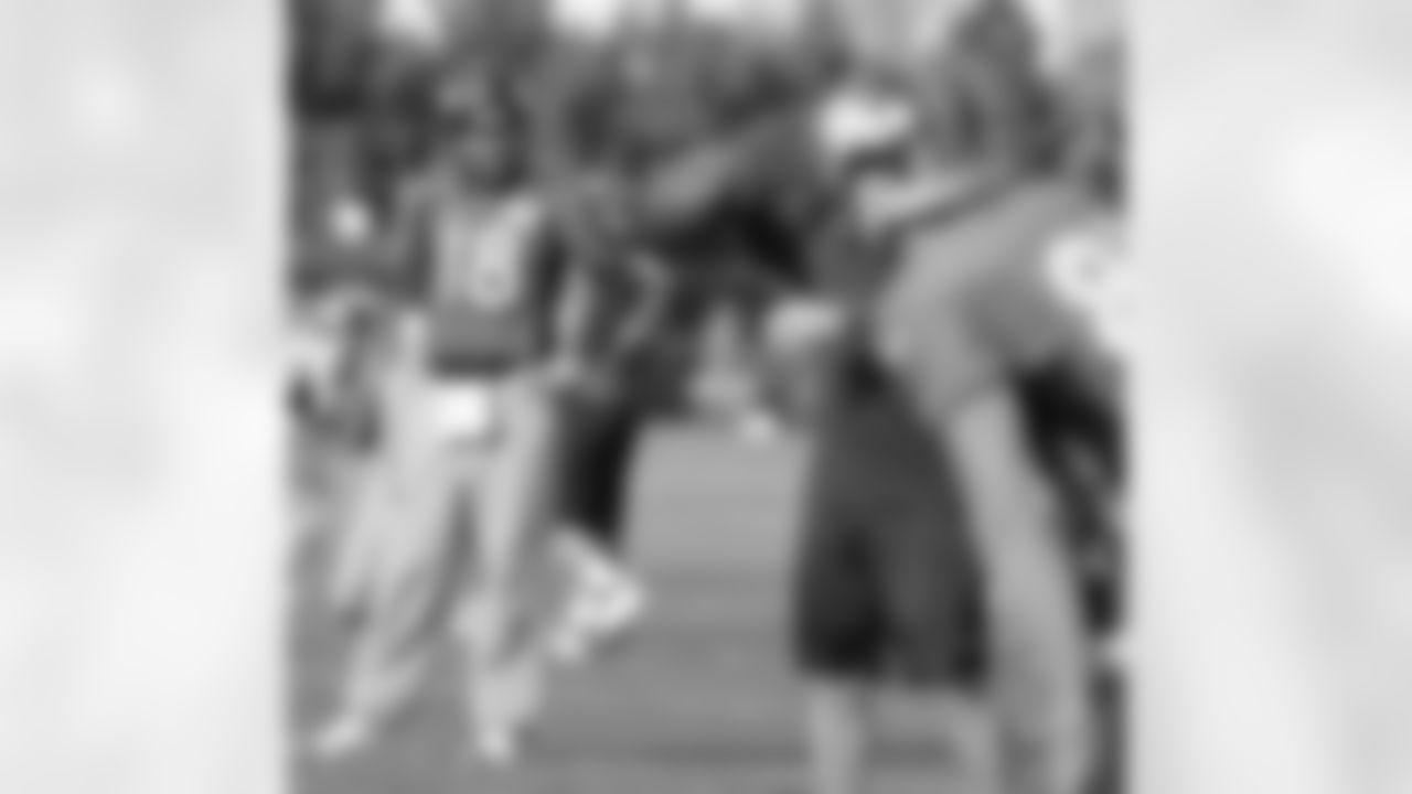 The quarterback works through practice with the receivers.