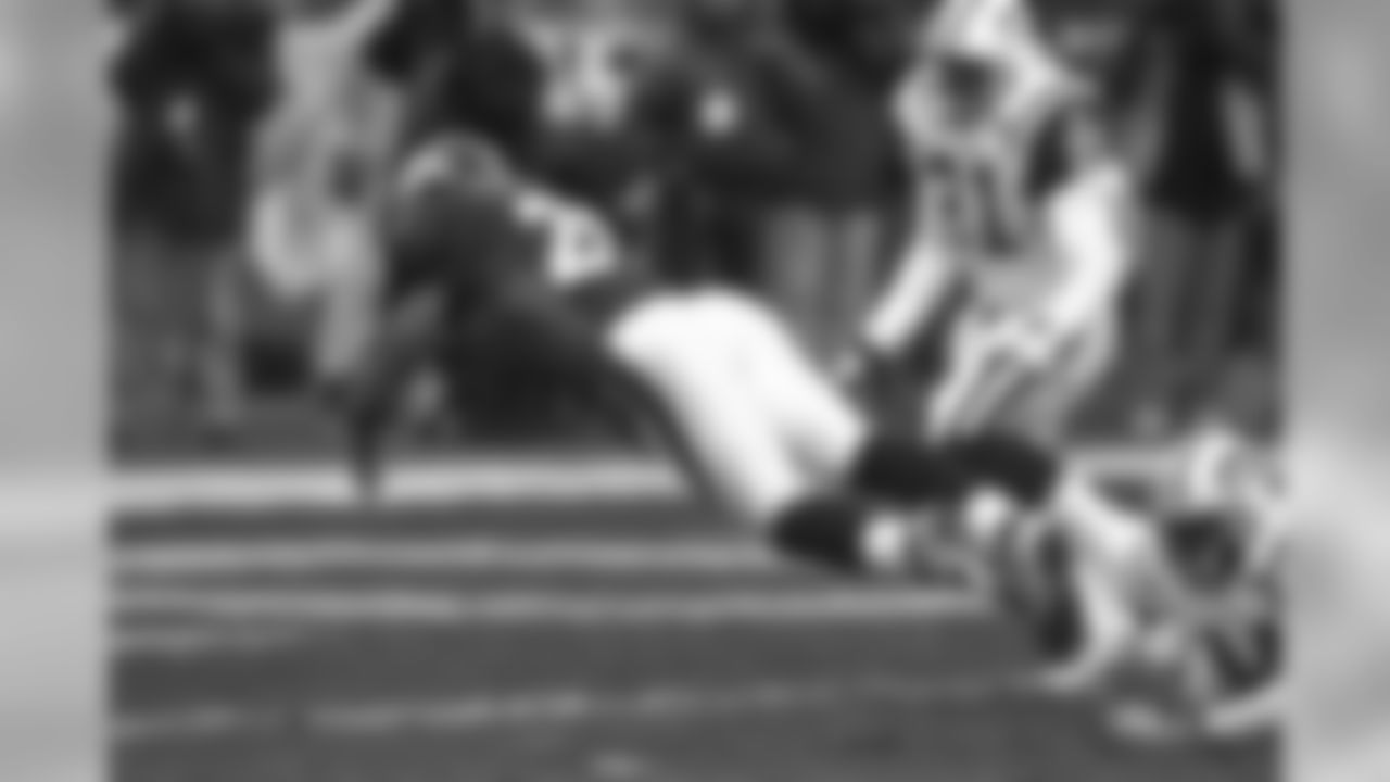 Howard Griffith breaks a tackle and leaps into the endzone against the New York Jets at Mile High Stadium in Denver, CO on January 17, 1999.