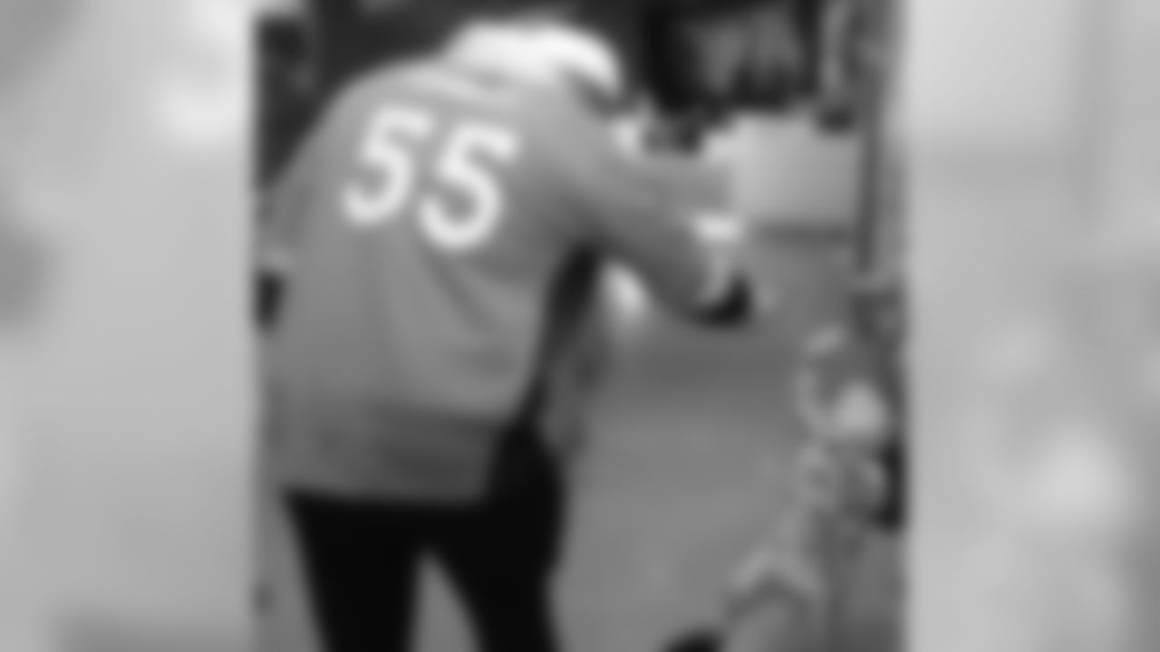 Bradley Chubb high-fives a patient during a Build-A-Bear distribution at Children's Hospital Colorado in Aurora on December 17, 2018.