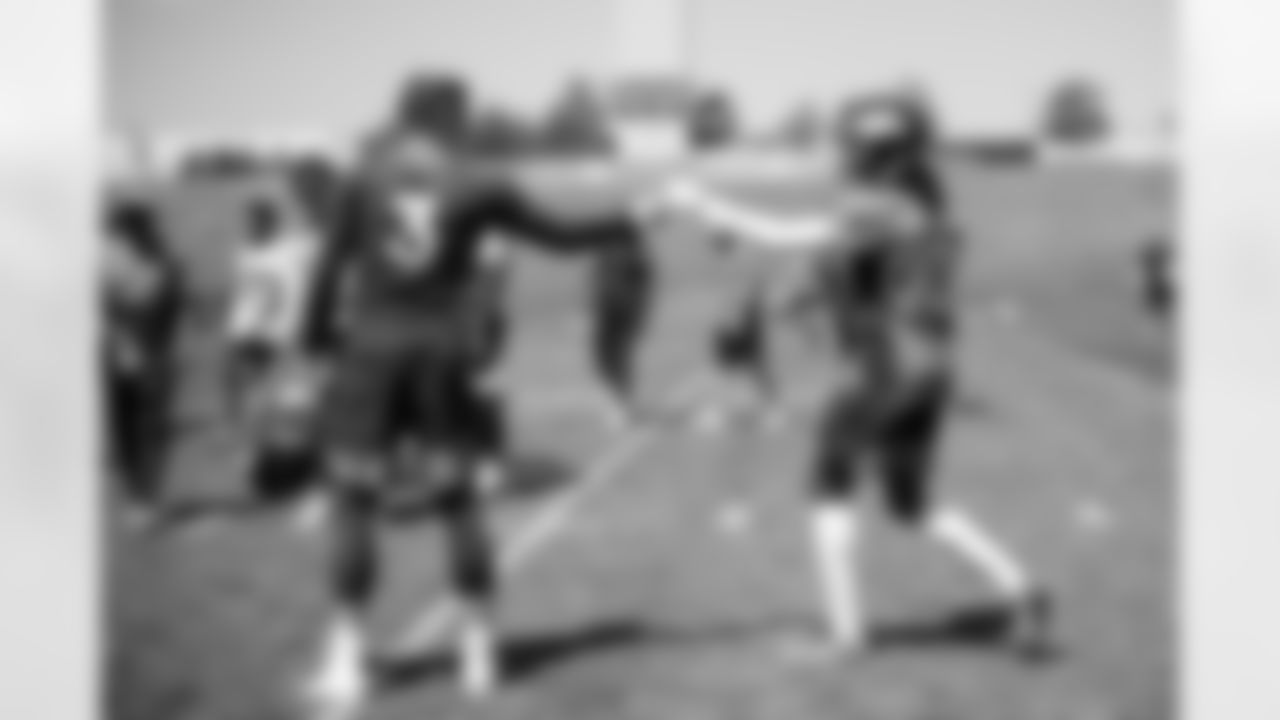Drew Lock shares a fist-bump with Jerry Jeudy during the eighth day of OTA practices at UCHealth Training Center on June 8, 2021. (Photo by Ben Swanson)