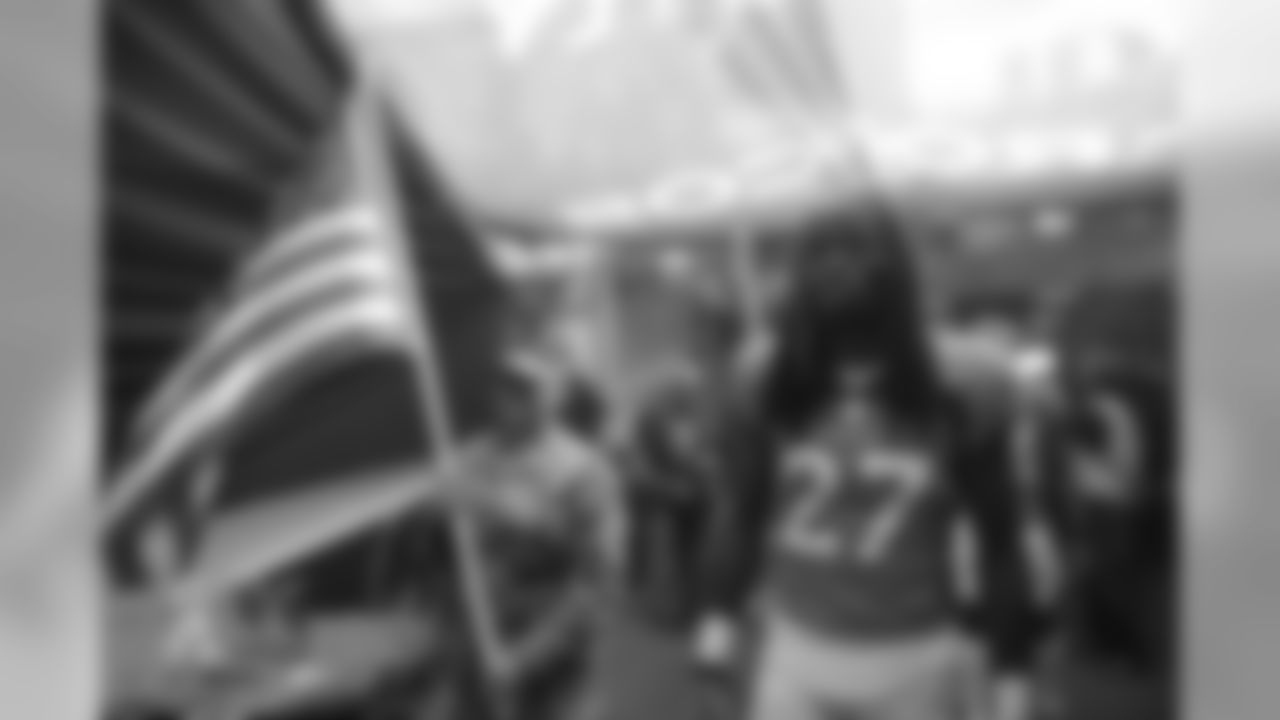 Davontae Harris and a member of the Navy in the tunnel before the Broncos' game against the Cleveland Browns at Empower Field at Mile High on November 3, 2019. (Photo by Ben Swanson)