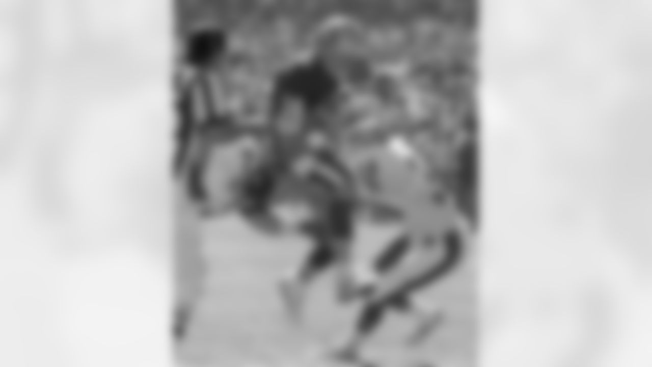 Broncos defensive end Greg Kragen (71) and defensive back Tyrone Braxton (34) stop San Francisco quarterback Joe Montana (16).