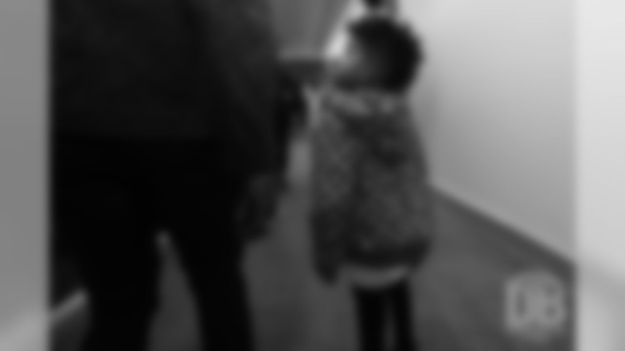 Emmanuel Sanders' son Princeton looks up at his dad during a visit to the Colorado Rockies' clubhouse at Coors Field on May 29, 2019.