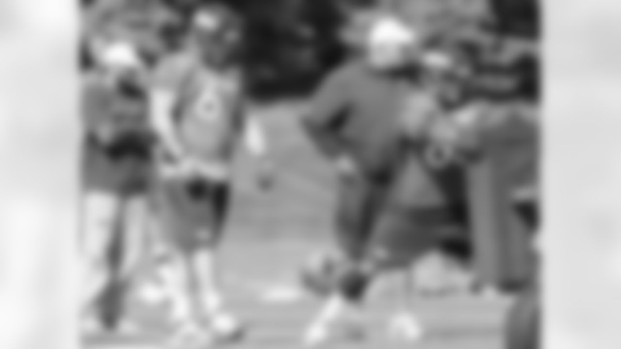 The offensive line works on their blocking technique.