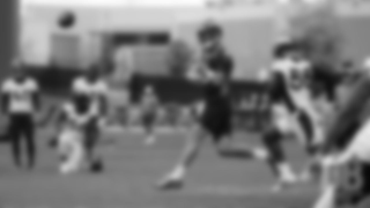 Joe Flacco throws on the run during the Broncos' second mandatory minicamp practice on June 5, 2019.