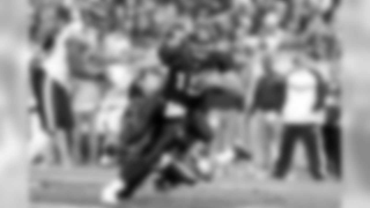 Broncos quarterback Tim Tebow scrambles up the middle for 5 yards during second-quarter action against the Chicago Bears in the NFL game on December 11, 2011 at Sports Authority Field at Mile High in Denver, CO.