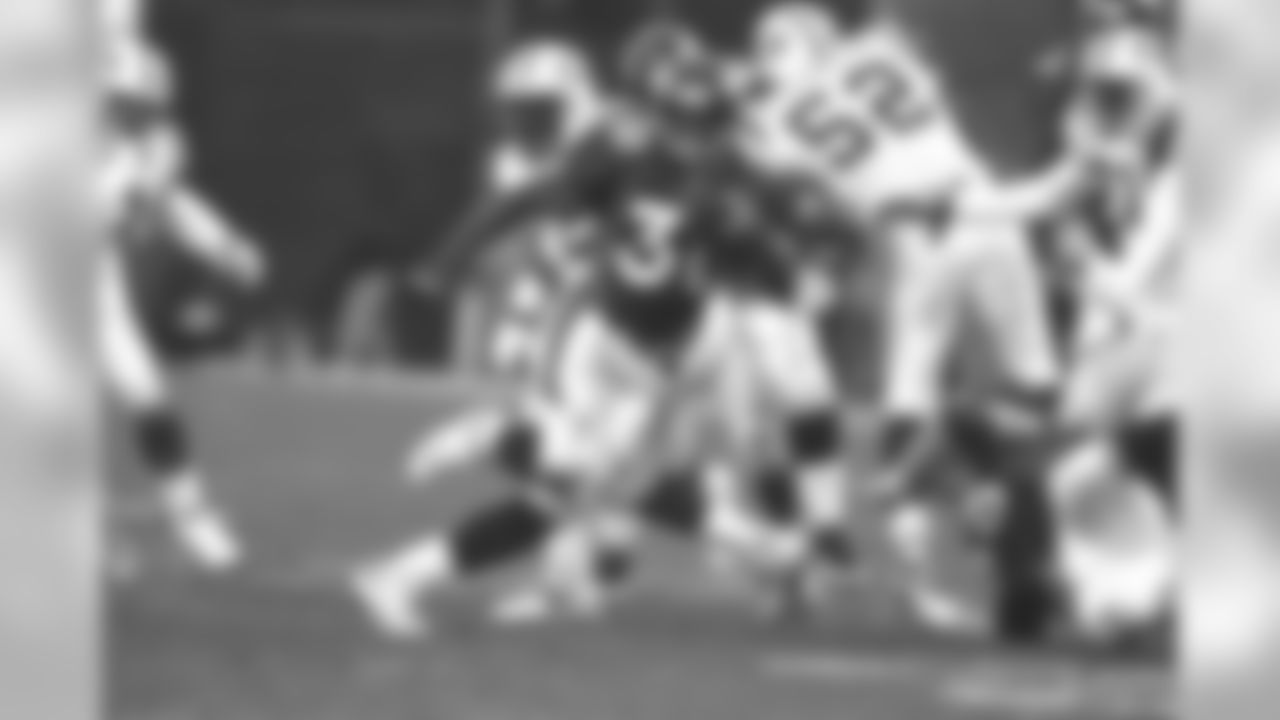 Terrell Davis, who rushed over 100 yards for the sixth-consecutive postseason game, churns up the field in the 1998 AFC Championship.