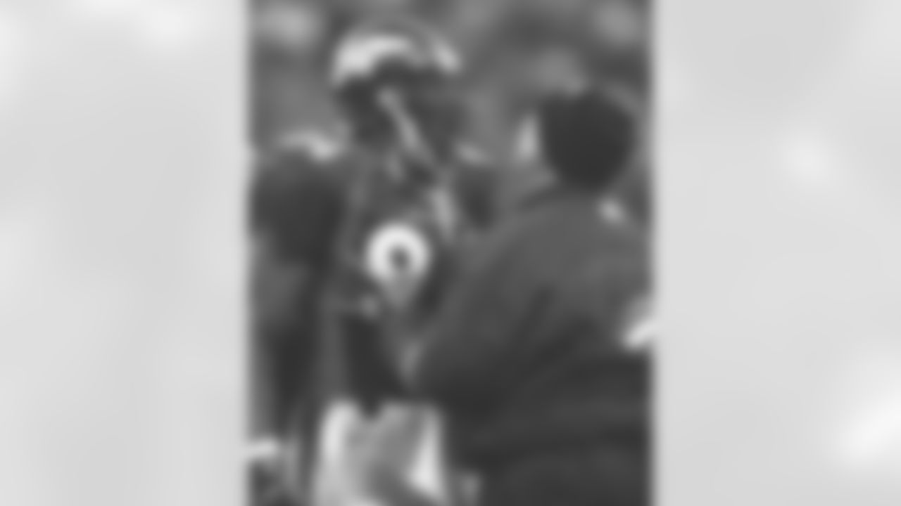 Shannon Sharpe is looked at by the head trainer, Steve Antonopulos, after taking a huge hit on the goal line against the New York Jets at Mile High Stadium in Denver, CO on January 17, 1999.