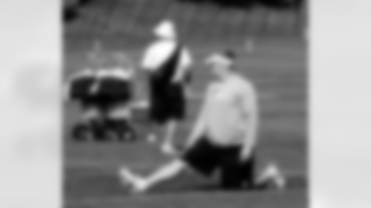 G Chris Kuper continues to recover from an injury as he stretches with the team.