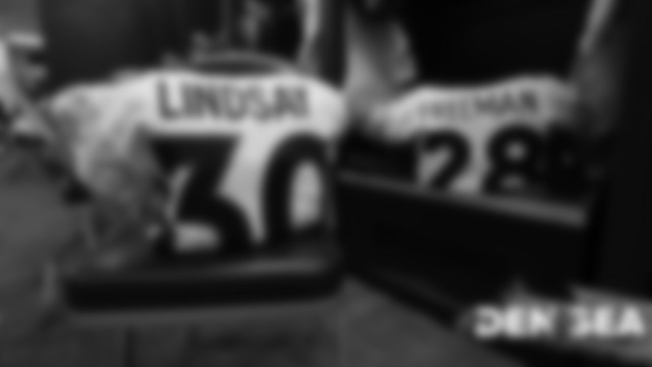 Phillip Lindsay's and Royce Freeman's jerseys in the visiting locker room for the Broncos' preseason game against the Seattle Seahawks at CenturyLink Field on August 8, 2019.