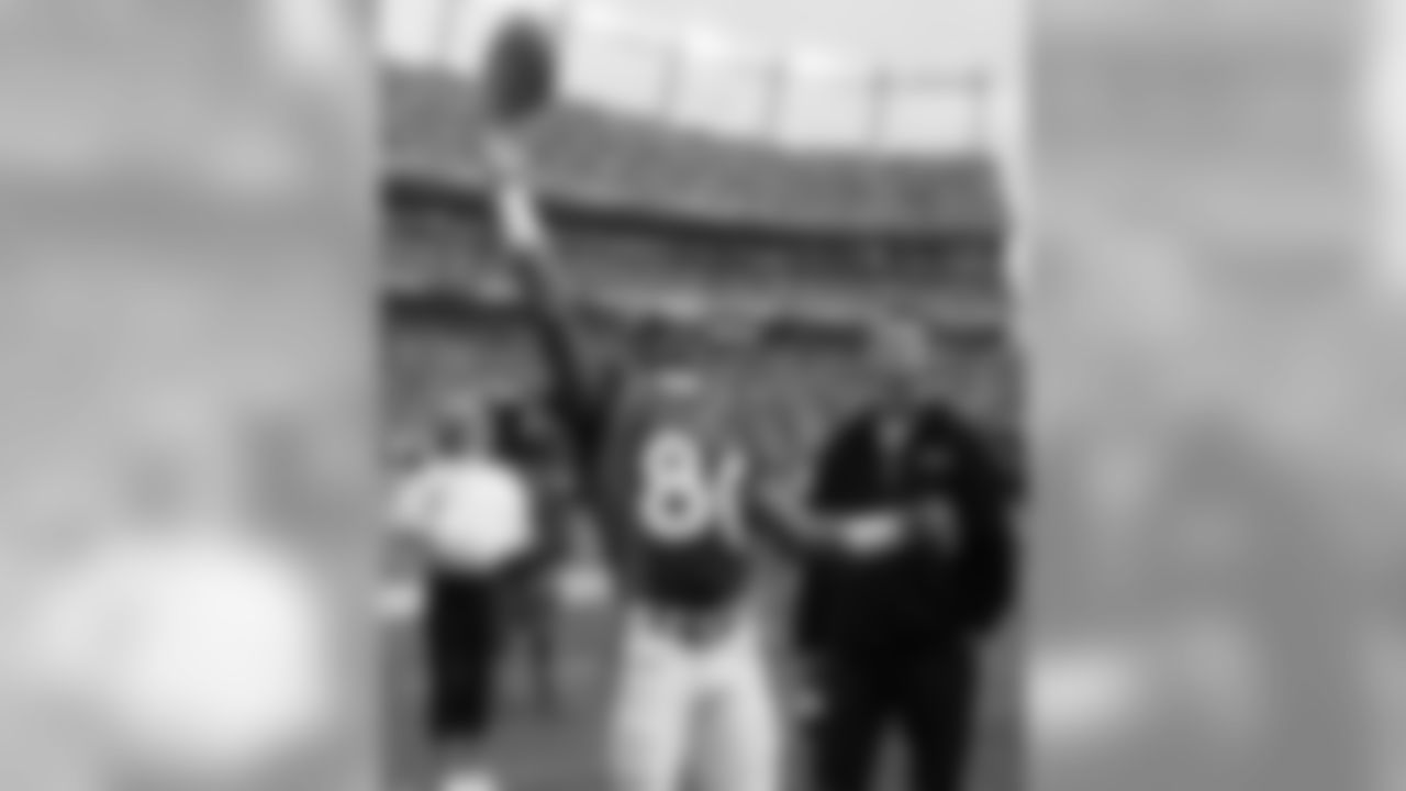 Smith tosses the ball in the crowd after catching a 2-yard pass for a touchdown in the second quarter against the Eagles in Denver on Sunday, Oct. 30, 2005.