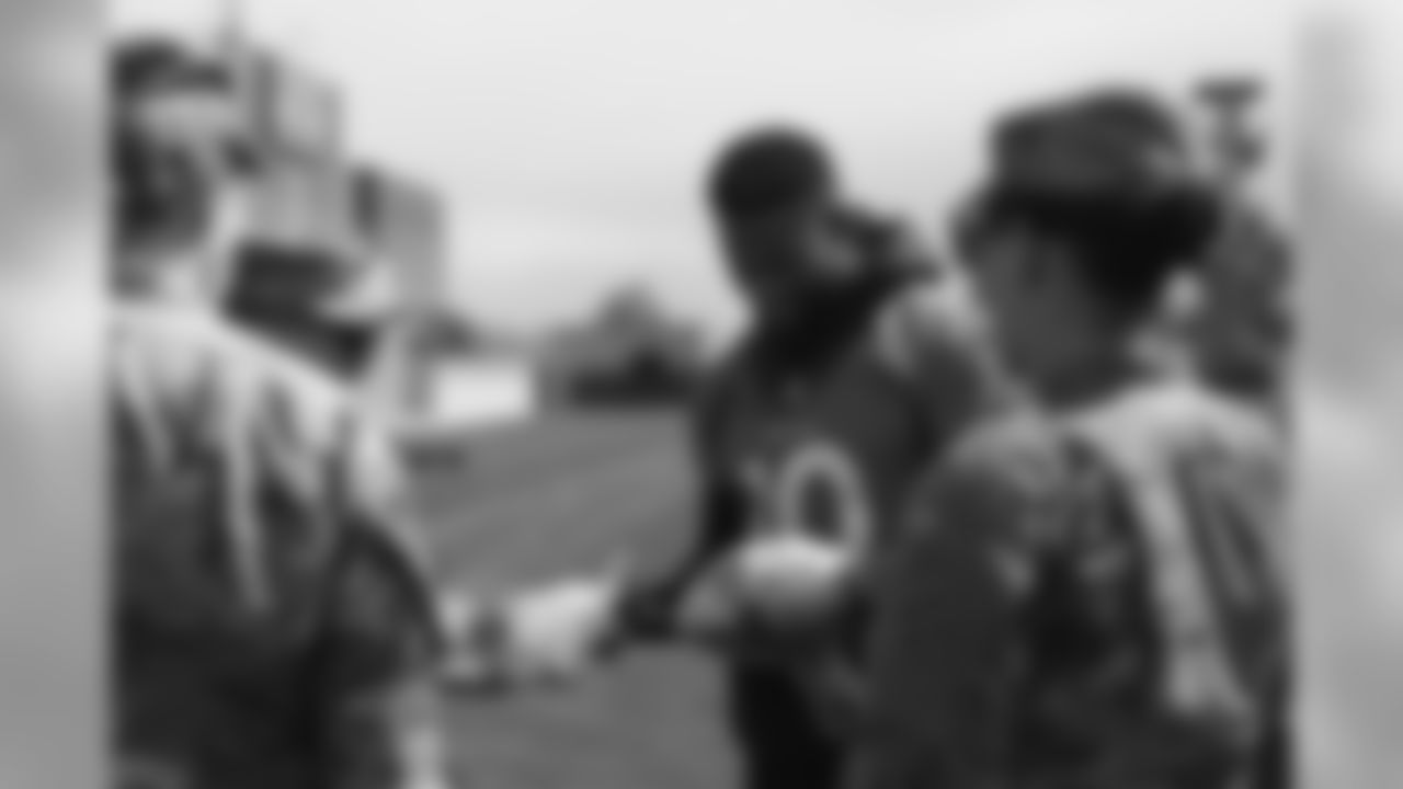 Emmanuel Sanders meets military members who visited and viewed practice as part of a USAA luncheon on June 4, 2019.