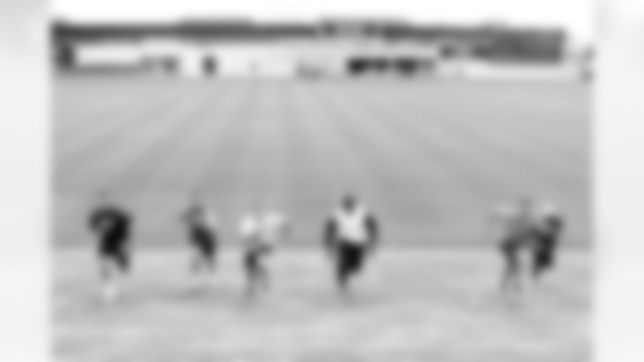 Paxton Lynch, Jake Butt, Chad Kelly, Austin Traylor, Jeff Heuerman and Case Keenum sprint up the berm at UCHealth Training Center.