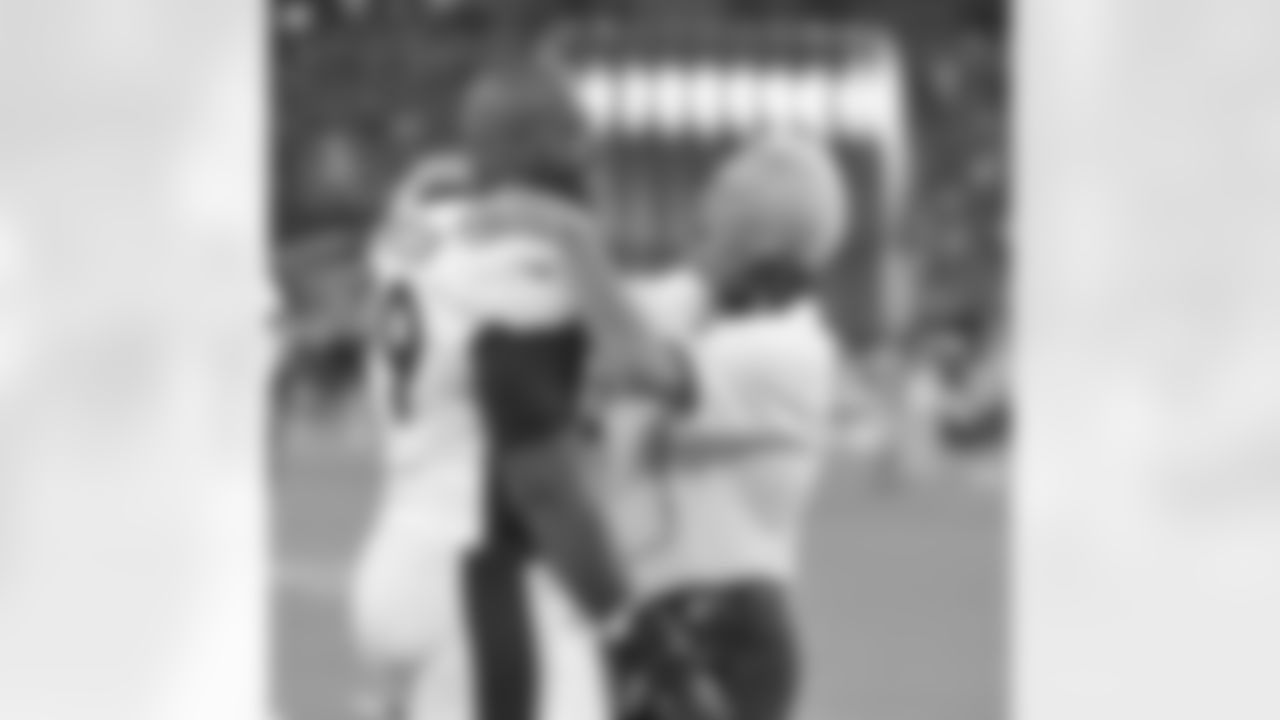 Defensive tackle Kevin Vickerson celebrates a big play with Head Coach John Fox.