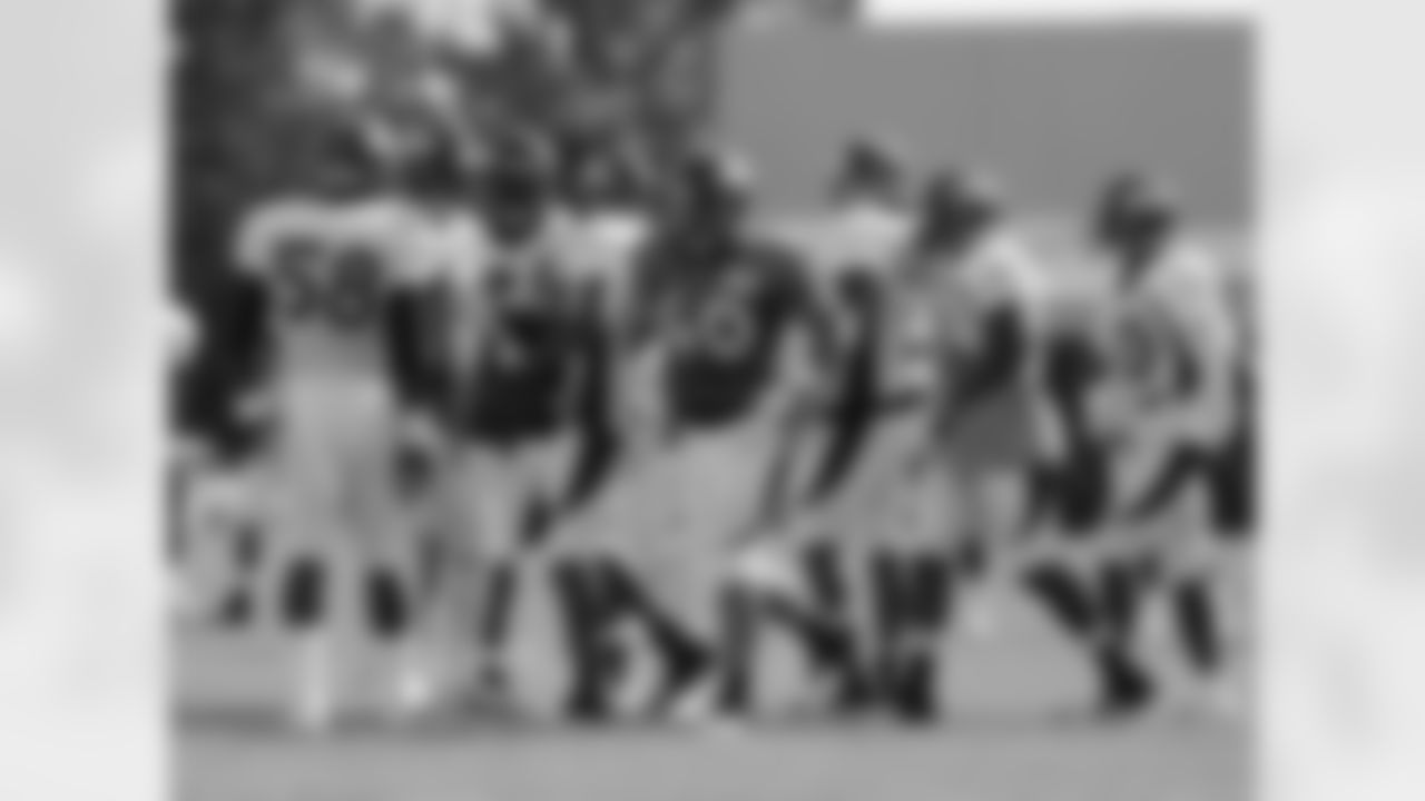 The defense celebrates Woodyard's interception.