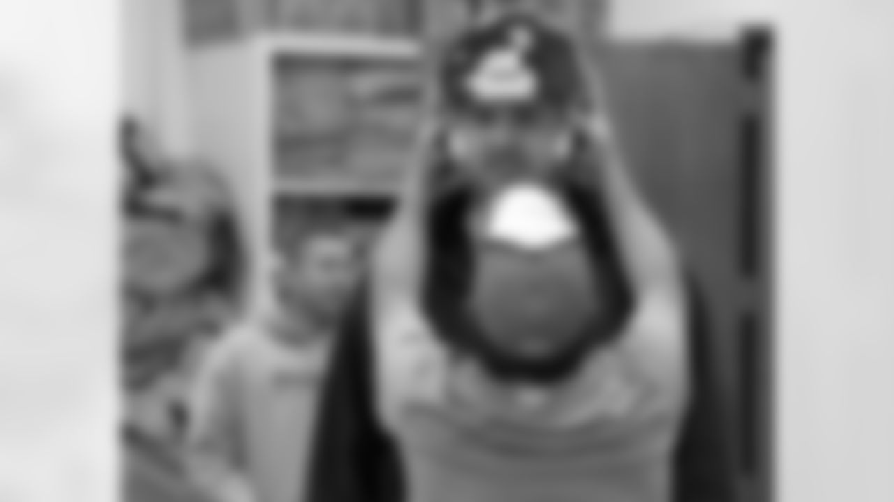 Valenti checks the fit on Schofield's helmet.