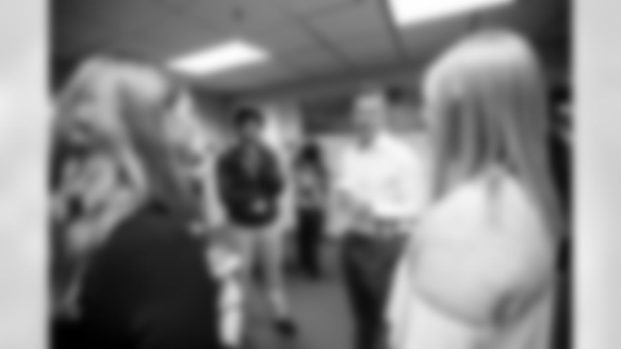 General Manager George Paton speaks with Broncos staff members during a visit to Empower Field at Mile High in Denver, Colorado on September 29, 2021. (Photo by Ben Swanson)