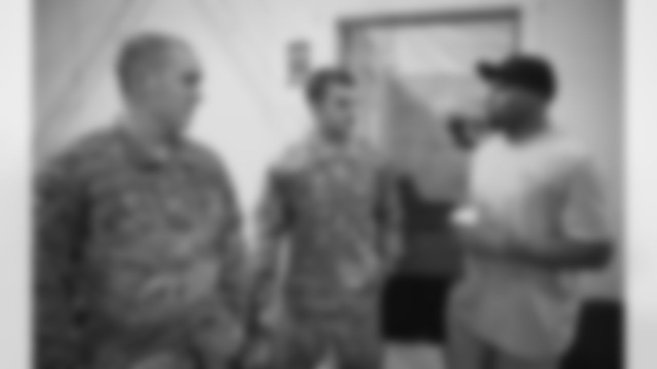Smith chats with members of the military.