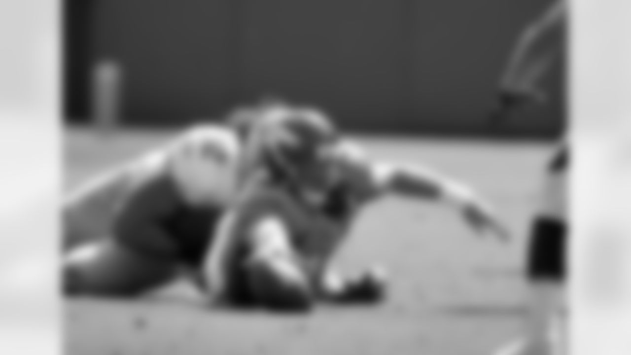 Quarterback Caleb Hanie dives to recover a loose ball.