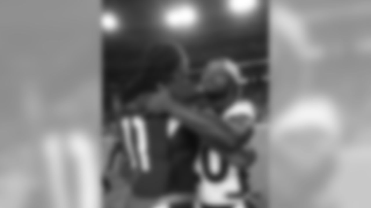 Adam Jones greets Cardinals receiver Larry Fitzgerald after the Broncos' preseason game against the Arizona Cardinals on August 30, 2018.