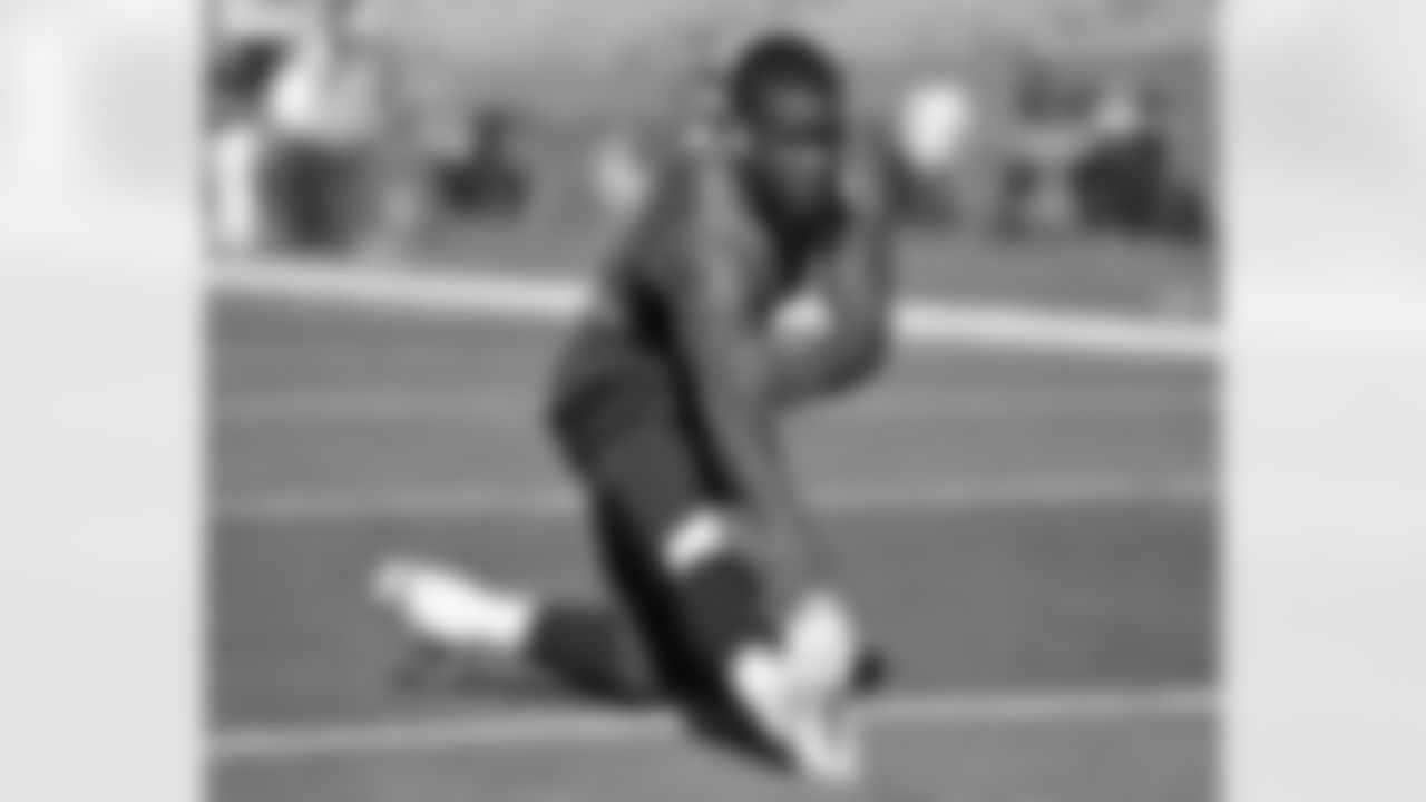 Rookie running back Ronnie Hillman stretches his legs on the field.
