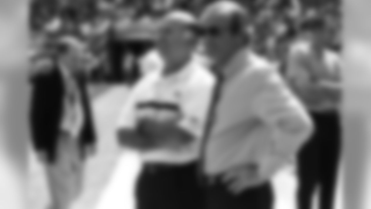 Pat Bowlen (right) chats with Steve Antonopolous (left) during the pregame drills against the St. Louis Rams at Invesco Field at Mile High in Denver, CO on September 8, 2002.