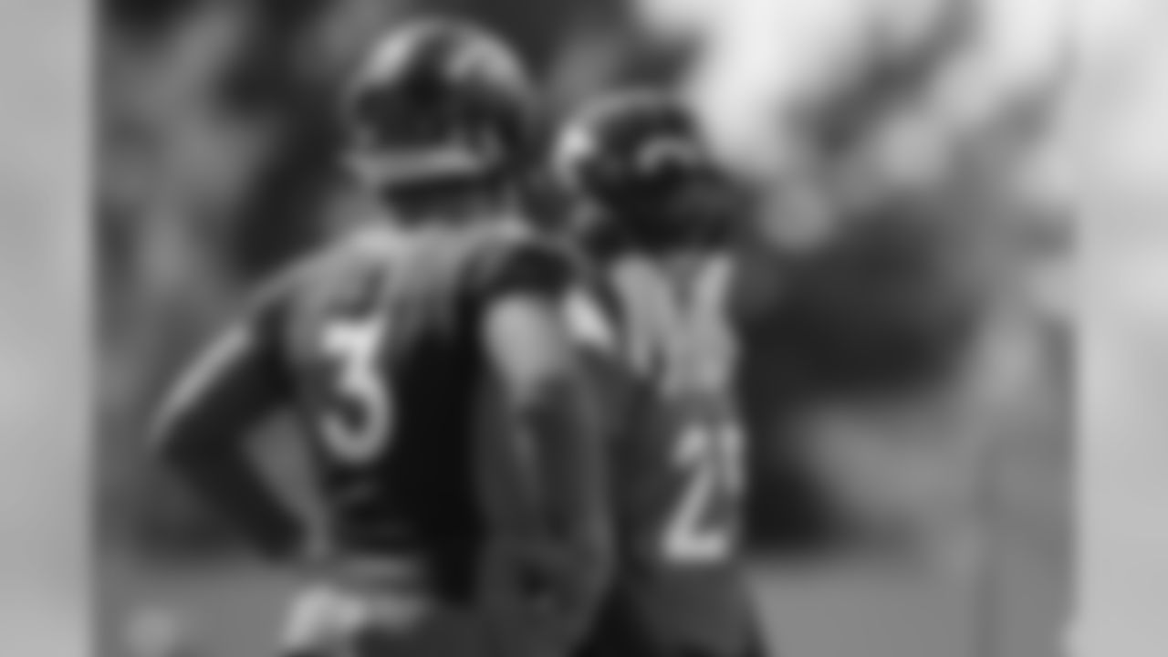 Drew Lock talks with Melvin Gordon III during practice at UCHealth Training Center on August 12, 2020. (Photo by Ben Swanson)