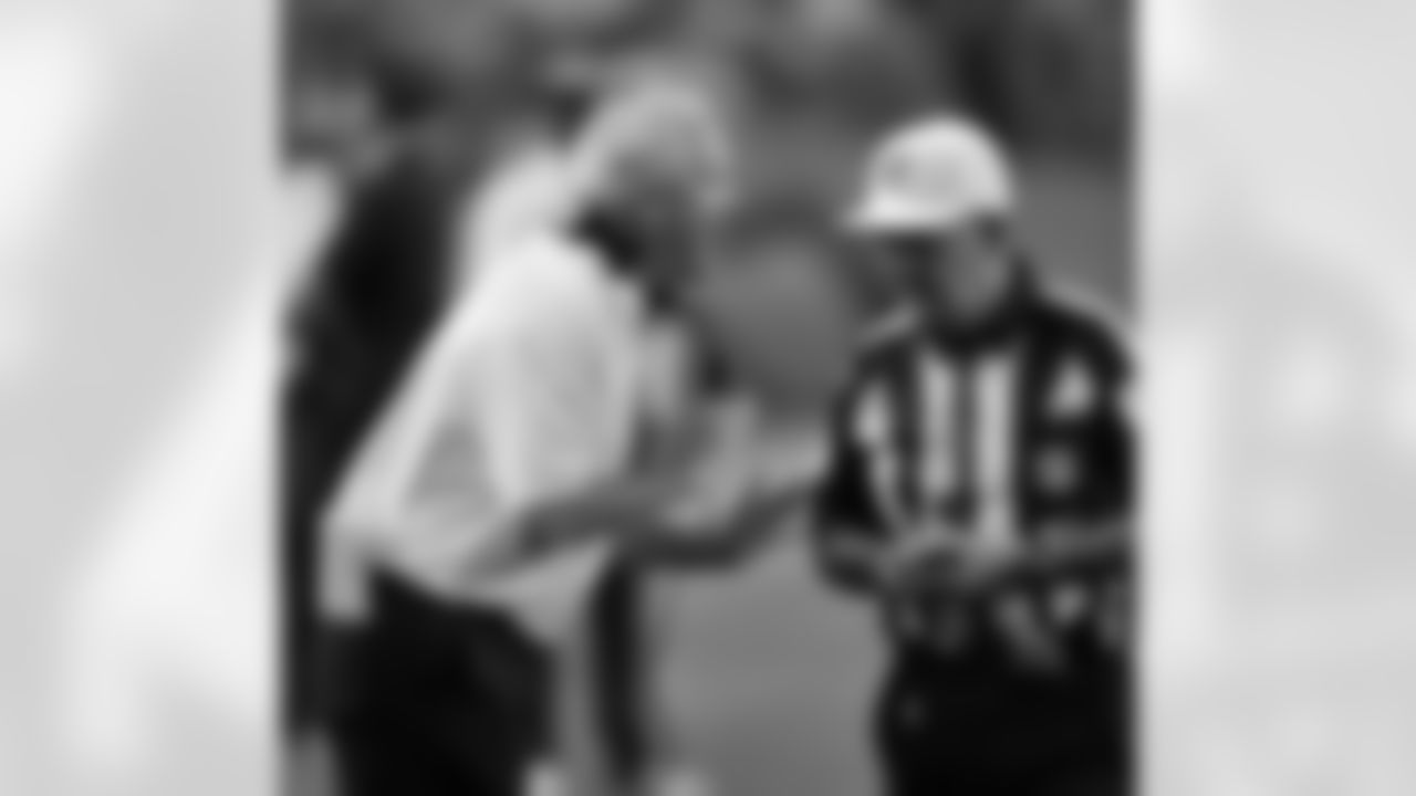 Head Coach John Fox speaks with an official.