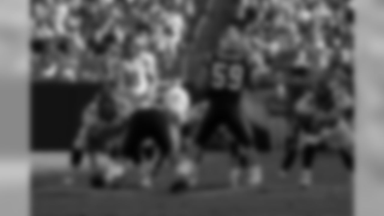 In Peyton Manning's second game in Charlotte, he threw for 301 yards and one touchdown. On the other side in this photo, linebacker Luke Kuechly was still in his rookie season but would become the AP NFL Defensive Player of the Year in his next season