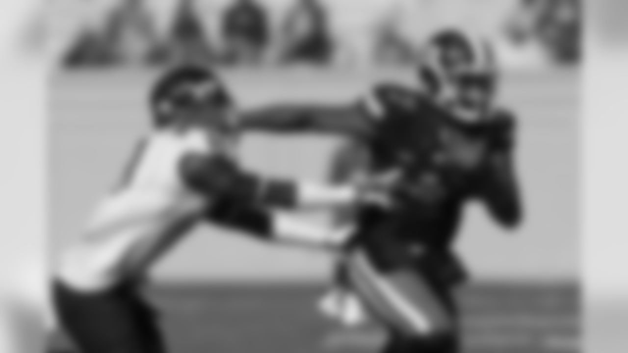 Duke quarterback Anthony Boone stiff arms Vetrick Bonner of Virginia Tech as Boone looks to run the ball.