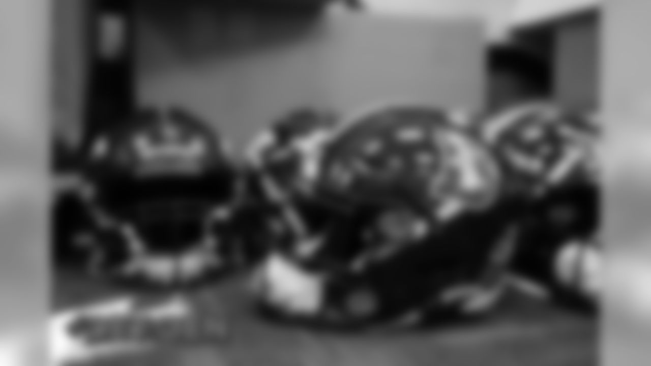 Members of the equipment staff apply new Color Rush stripes and throwback logo decals onto helmets ahead of the team's Week 16 game against the Lions on December 17, 2019 at UCHealth Training Center. (Photo by Ben Swanson)