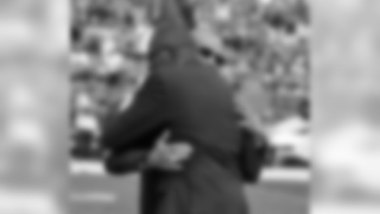 The owner and wideout share an emotional embrace.