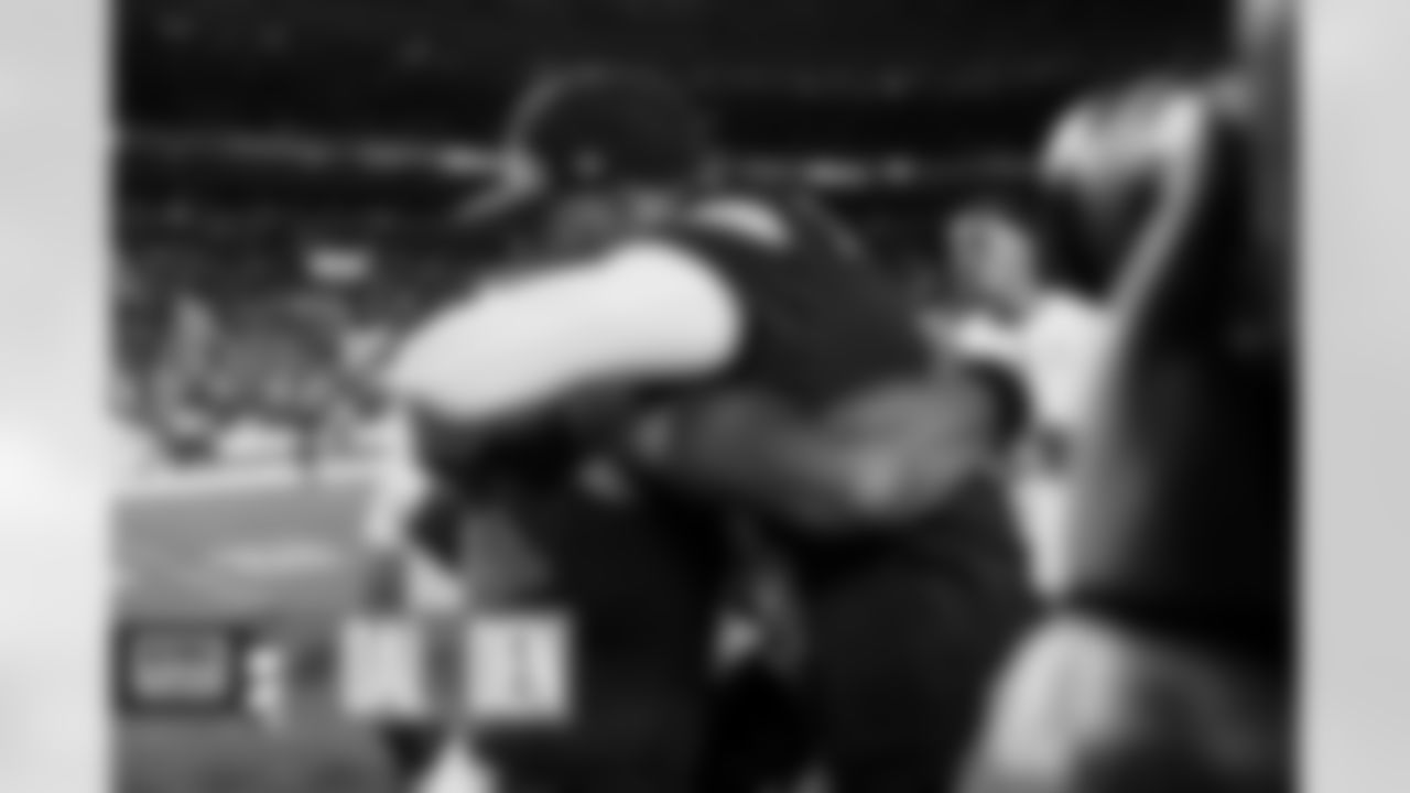 Russell Wilson hugs Dak Prescott after the Broncos' preseason Week 1 game against the Dallas Cowboys at Empower Field at Mile High in Denver, Colorado on August 13, 2022. (Photo by Ben Swanson)