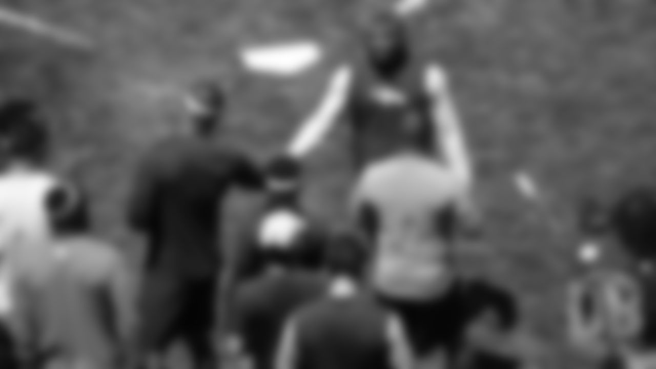 Von Miller high-fives Royce Freeman during the Broncos field day on June 6, 2019.