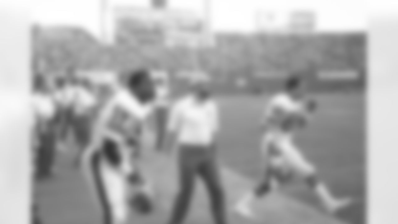 Tom Jackson on the sidelines watches a play against the Chargers.