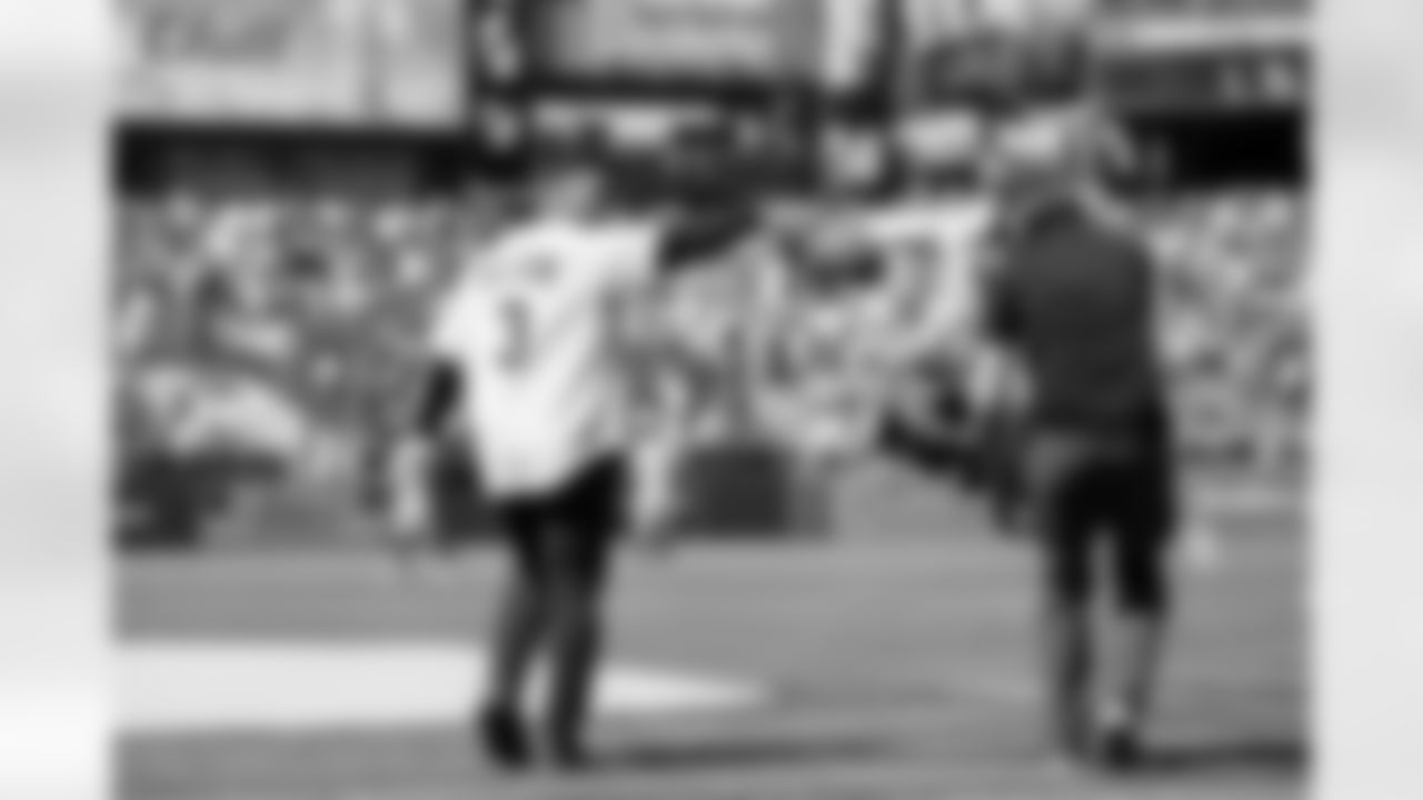 Russell Wilson walks out to the mound to throw out the first pitch during his visit to the Colorado Rockies' Opening Day game at Coors Field in Denver, Colorado on April 8, 2022. (Photo by Ben Swanson)