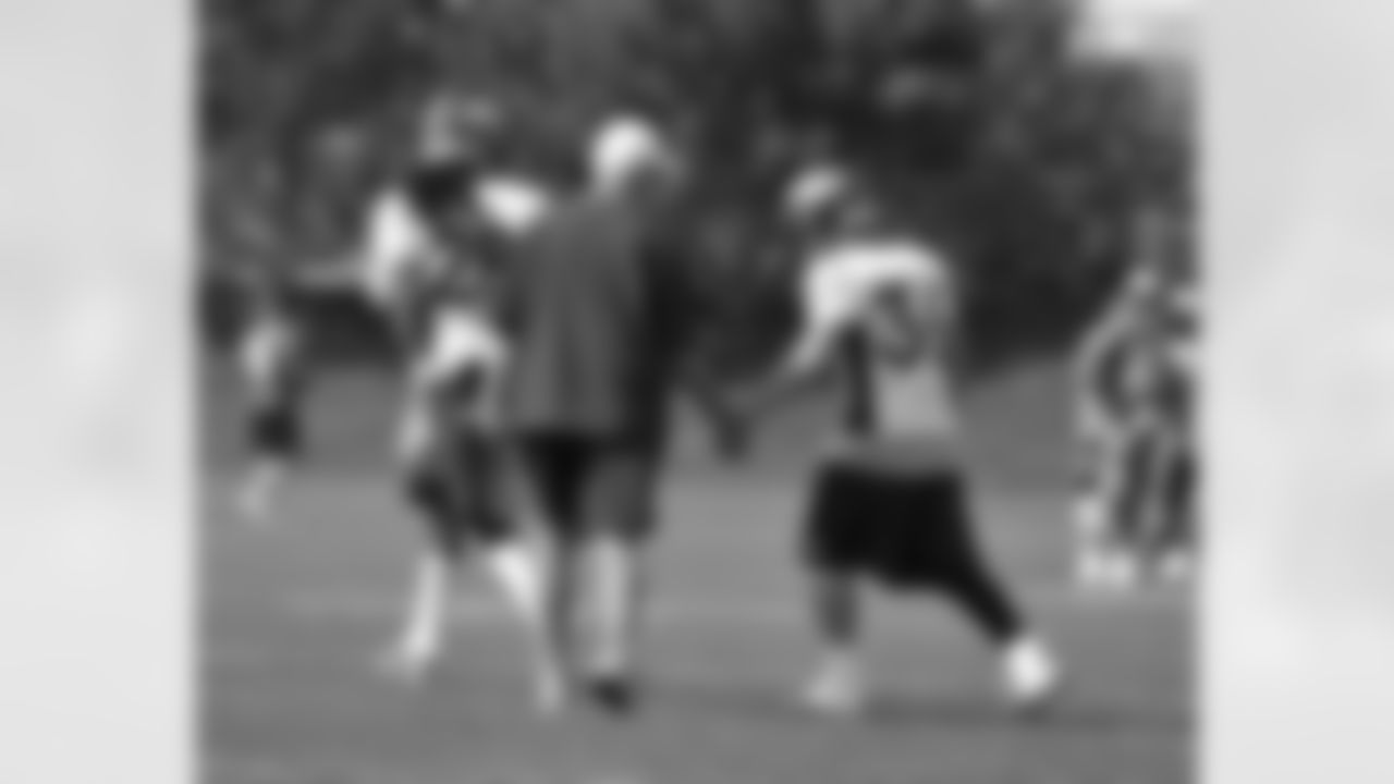 Fox gives some encouragement to S Jim Leonhard as he trots out to drills.