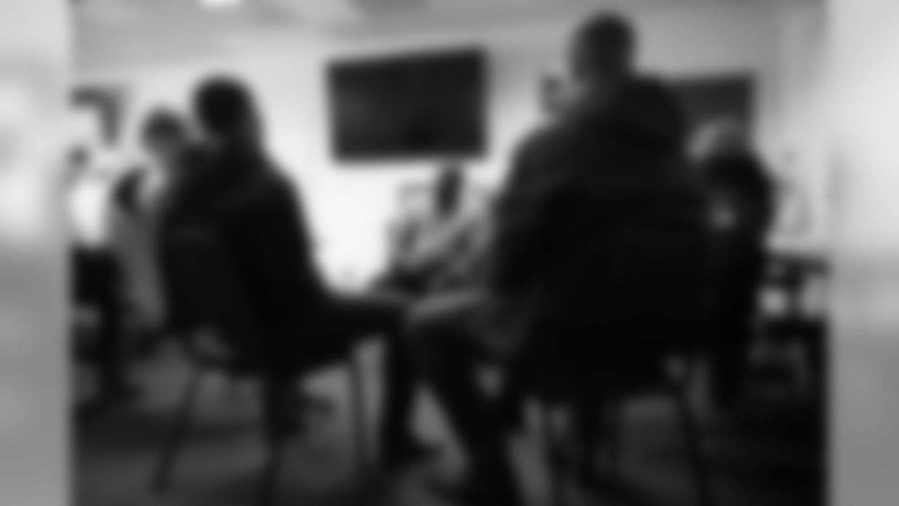 Isaac Yiadom, Andrew Beck and Khalfani Muhammad and Garett Bolles talk with technician Tyrone Campbell during an immersive training experience at the Denver Police Academy on October 28, 2019. (Photo by Ben Swanson)
