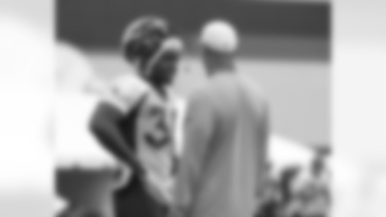 Ball talks to RB Coach Eric Studesville.