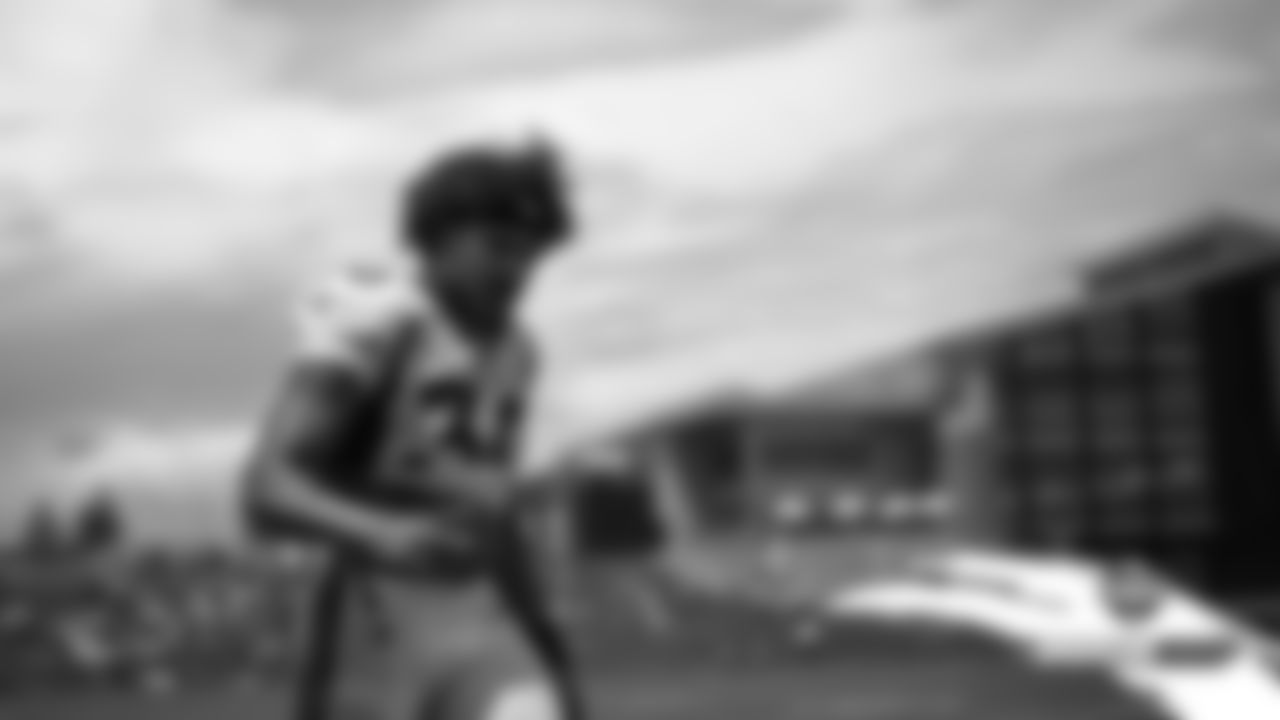 Phillip Lindsay walks off the field after practice on Day 7 of training camp on July 25, 2019.