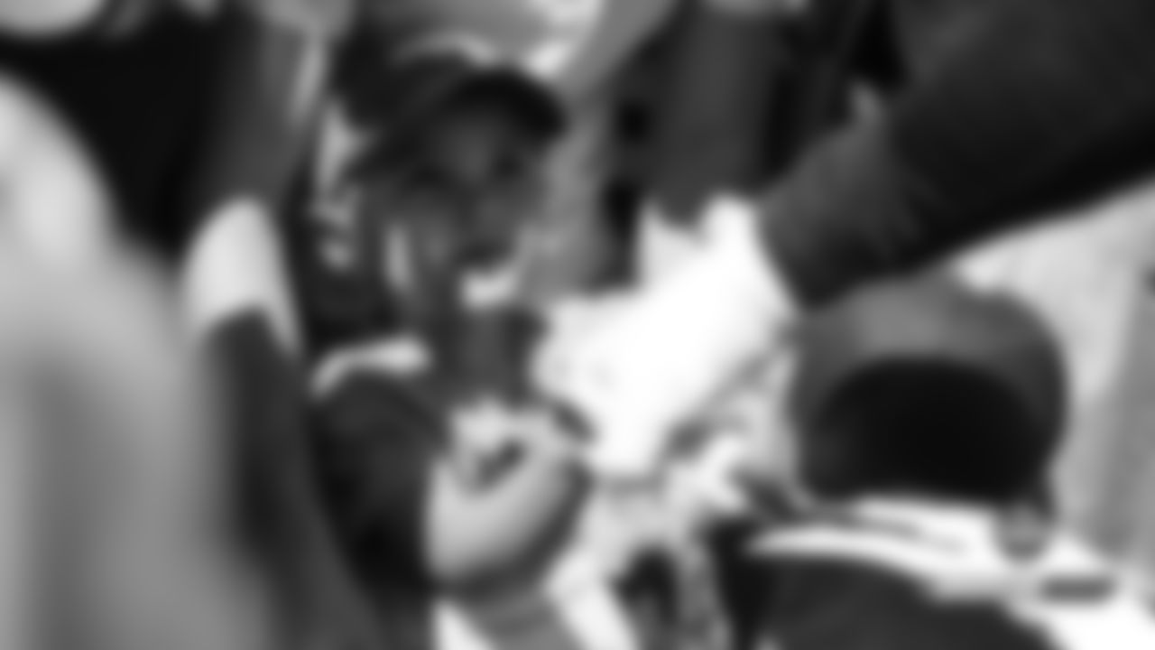 A young fan gets a fist bump from Von Miller after practice on Day 16 of training camp on August 12, 2019.
