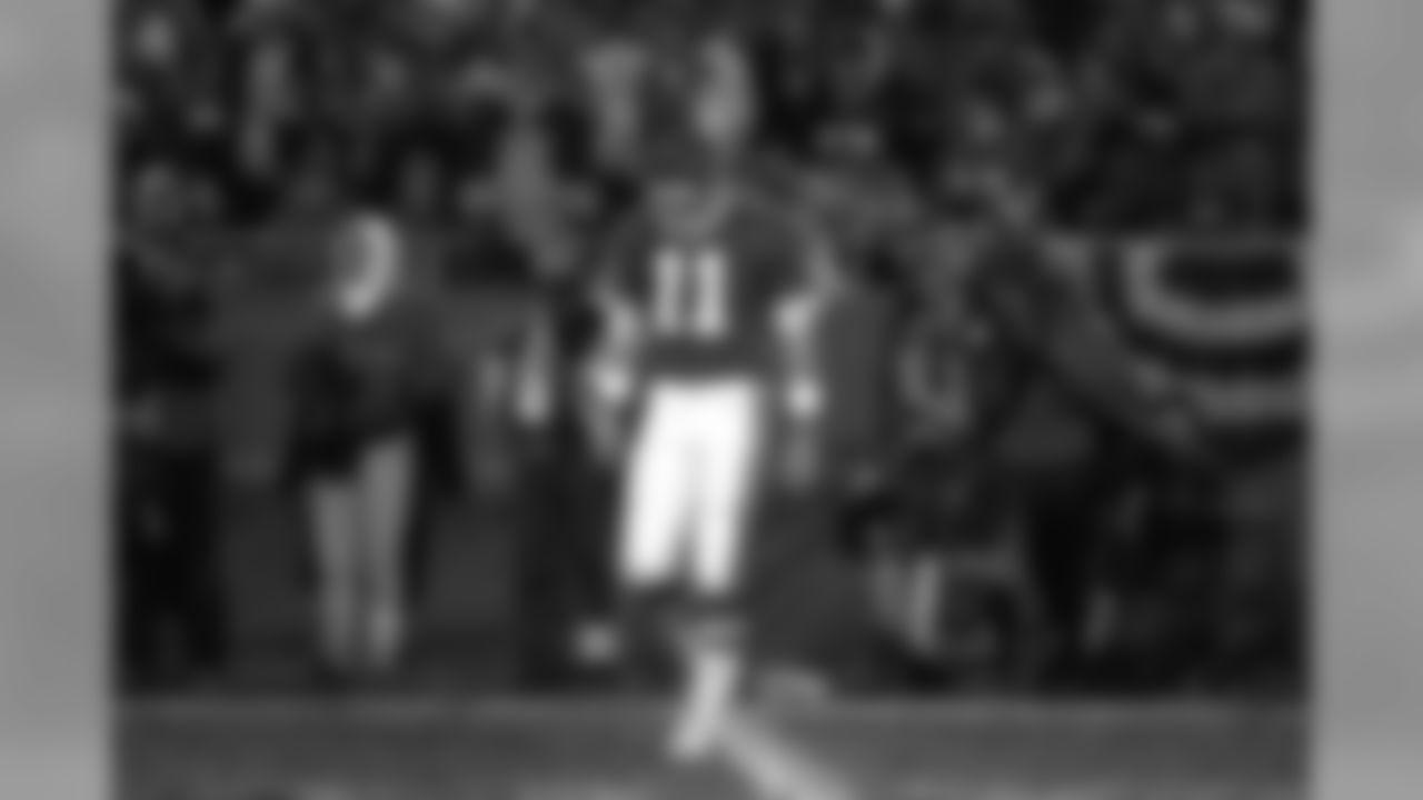 Elvis Grbac walks onto the field dejectedly as Kansas City falls behind the Broncos in a second-round playoff game against the Kansas City Chiefs at Arrowhead Stadium in Kansas City on January 4, 1998.