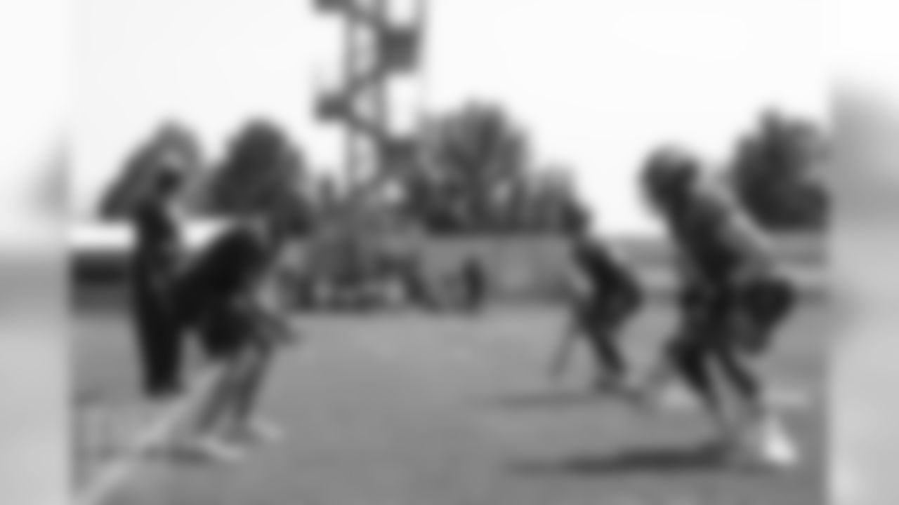 Wide Receivers Coach Zach Azzanni instructs receivers wide receiver John Diarse (9, far right) and wide receiver Mark Chapman (85, left of Diarse) during a practice at UCHealth Training Center on Aug. 13, 2018.