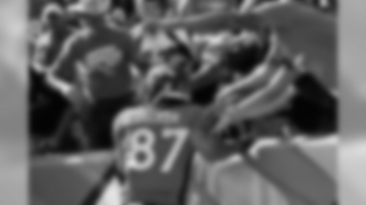 WR Eric Decker jumps into the crowd following a 17-yard TD catch.